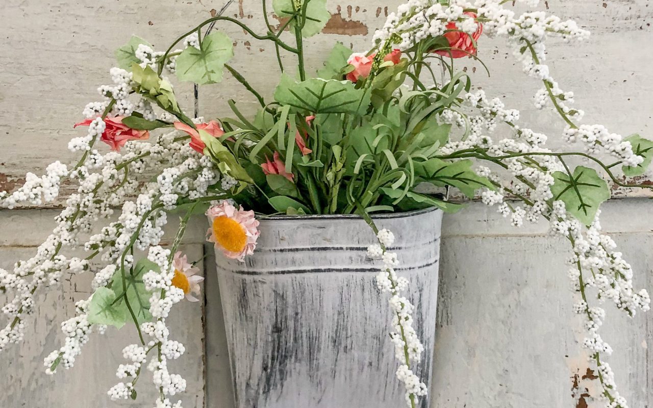 Spring faux flowers in a metal basket